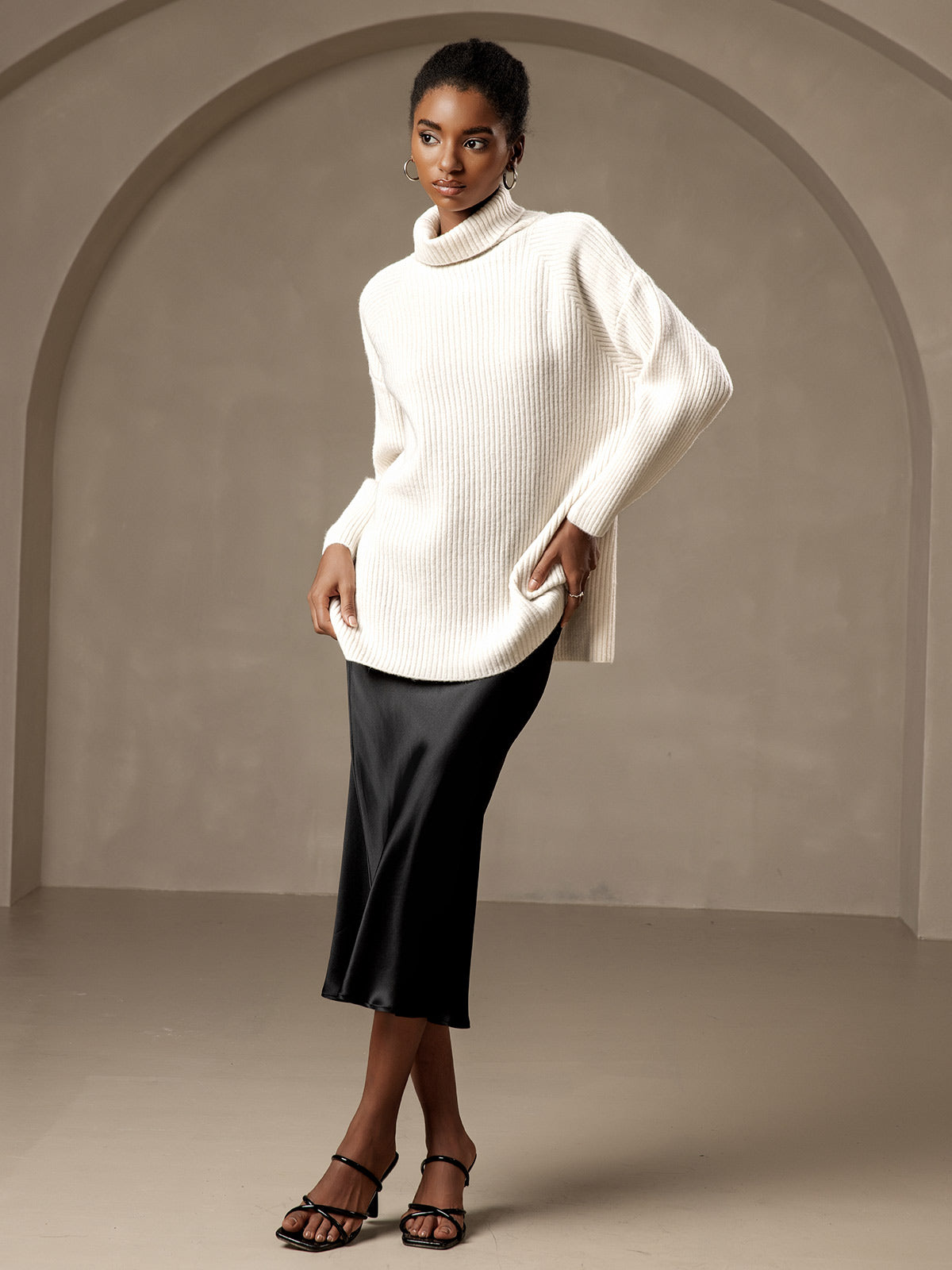 Black satin midi skirt with cream sweater for a cozy date night